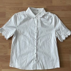 White button down with scallop detail on collar and sleeves.